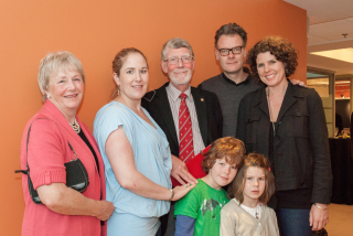William Foster flanked by his wife, children, and grandchildren. Photo by Lysanne Larose.