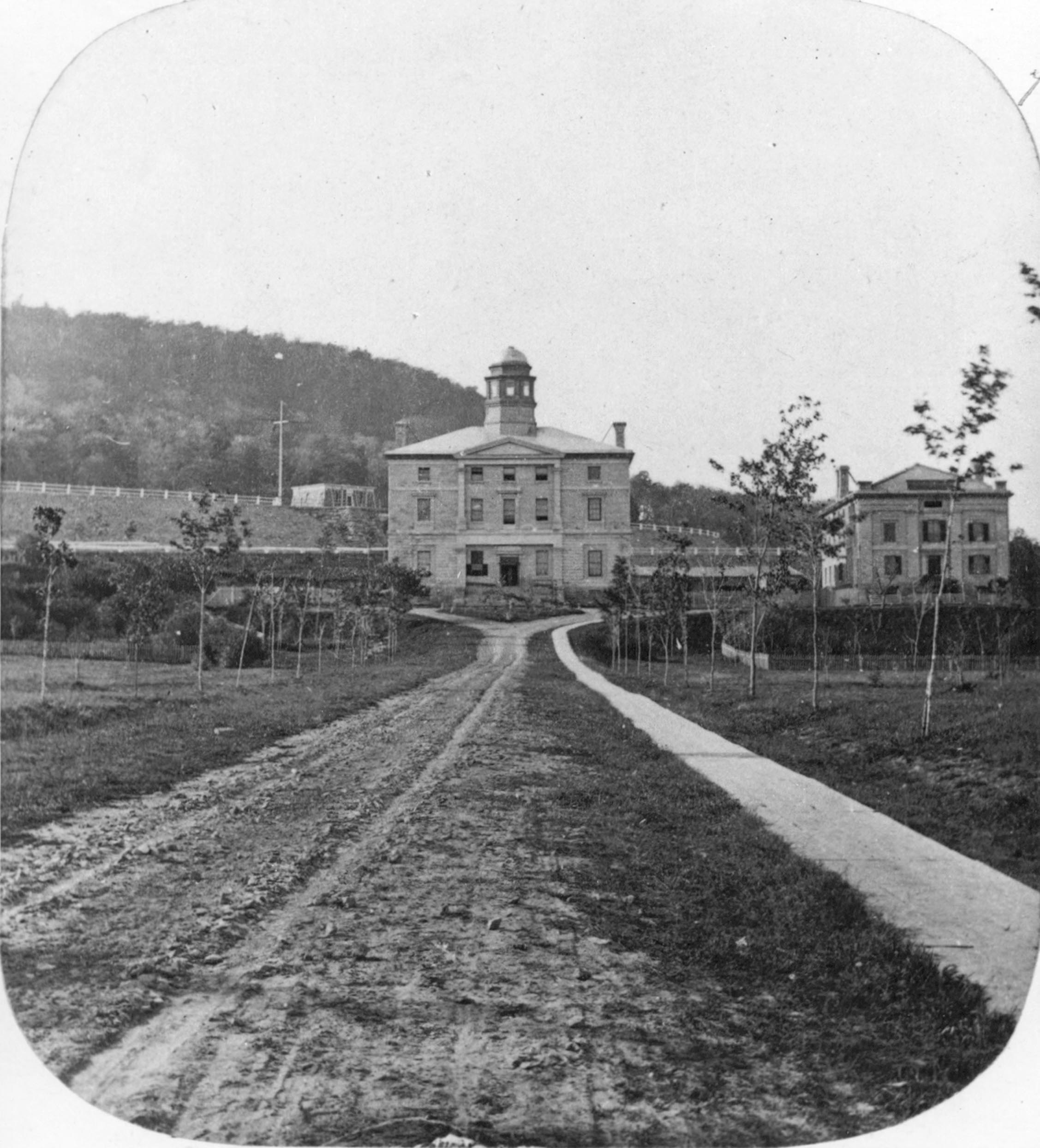 Black and white historical photograph from 1860 featuring the Arts Building at McGill University, photographed by William Notman.