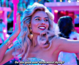 actress Margot Robbie performing in a dance routine in the film Barbie, asking the existential question, “do you guys ever think about dying?”