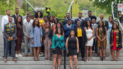A large group of Black students posing for a photo on campus
