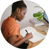 A lady writing in a book