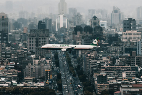 Photo of an airplane over a city