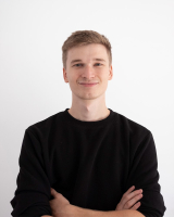 Max Leblanc, PhD student smiling crossed arms in front of a white background