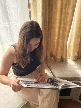 Hannah Murray reading a book from the Forbes library collection housed at the Maison Louis-Joseph Forget, which she spent the first month of her internship organizing. 