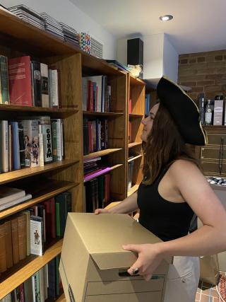 Throughout her internship with the 78th Fraser Highlanders, Hannah Murray organized and indexed various archival documents and historical monographs. Here, she prepares to sort through a box of archives. 