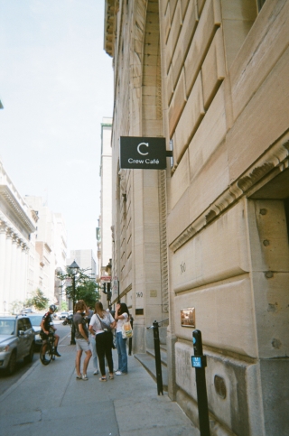 View from the street of the front of Crew Collective Café, with people gathered outside (Image by Chantay)