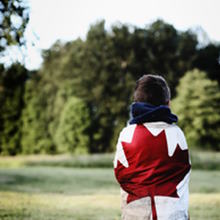 kid wearing the canadian flag | Photo by Ksenia Makagonova on Unsplash