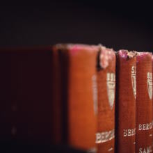 Red binded books arranged vertically |Photo by Laurenz Heymann on Unsplash