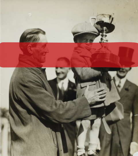 adult holding a child with award | Photo from the archives of Museum of Victories