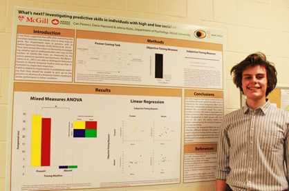 Undergraduate standing in front of their poster