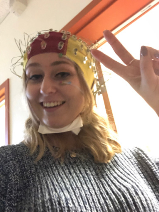 Abby Jakus wearing an EEG cap and ready to participate in an EEG study!