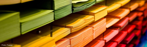 Stacks of colored papers in shelf units