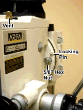 Drill press head showing locking pin and nut to allow the head to tip.