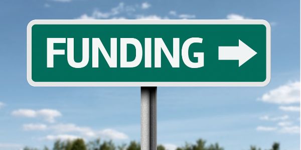 A sitreet sign that read funding with an arrow