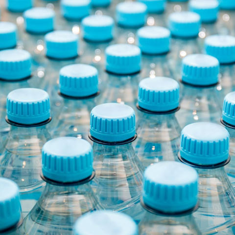 close up of water bottles with blue caps