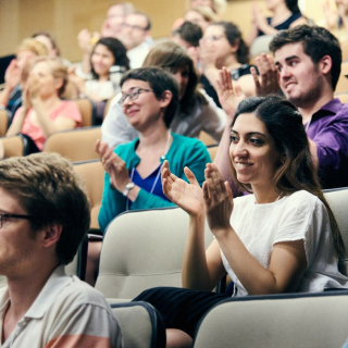students listening and clapping