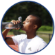 black man drinking water on a track field
