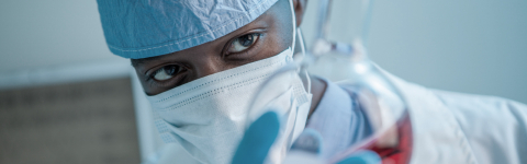 Student in a lab holding a flask