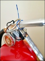 close up shot of safety pin on fire extinguisher