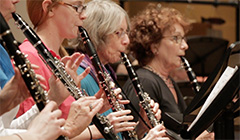 Women, young and old, playing clarinet