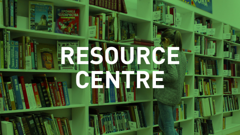 Resource Centre Student reading in front of library shelves, with "Resource Centre" label