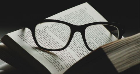Glasses resting on the pages of an open book