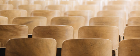 empty wooden seats in a classroom