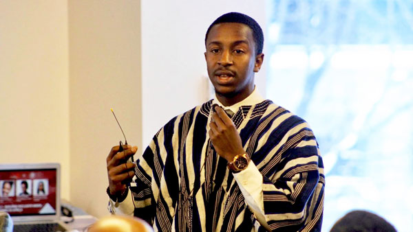 Photo of Abdel Dicko speaking in front of a classrom