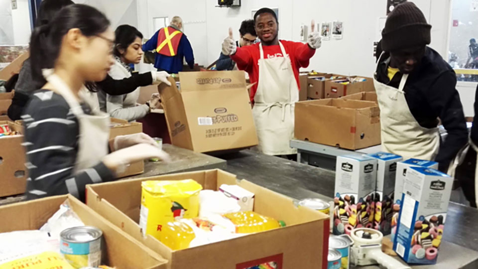 Students help package and distribute food at Moisson Montreal