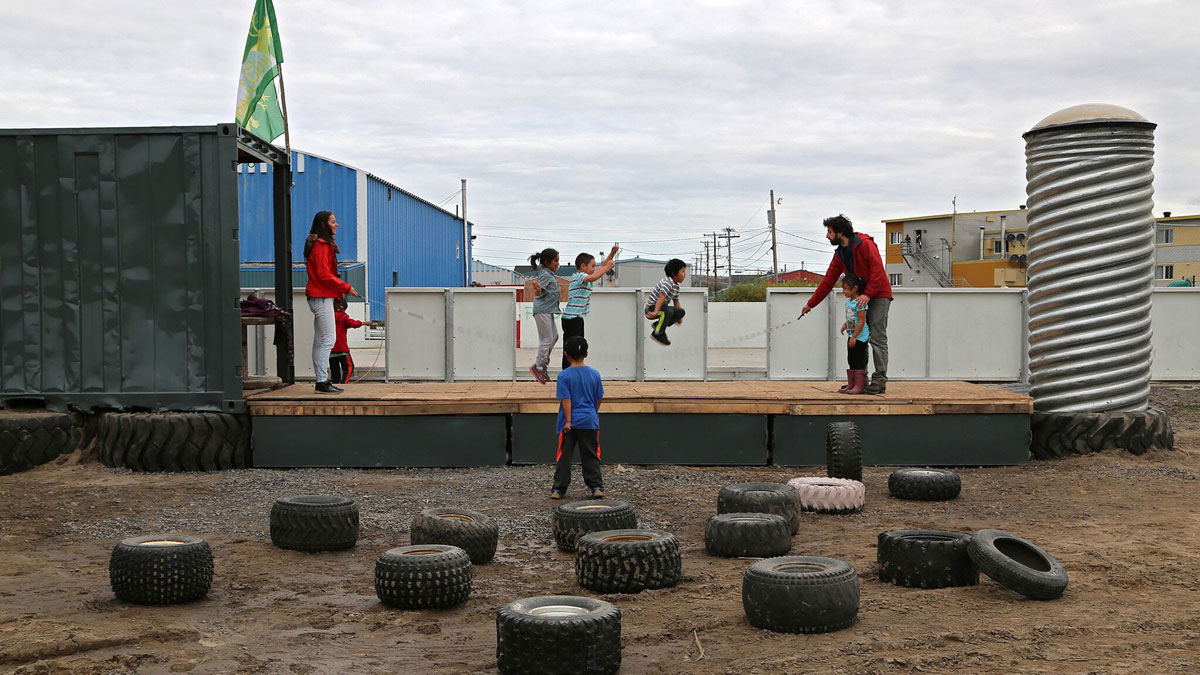 Kids jump rope on the new outdoor stage in Kuujjuaq