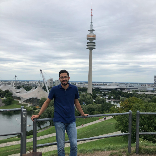 Photo of Mohamed Haj Ali in front of the Olympic Tower of Munich