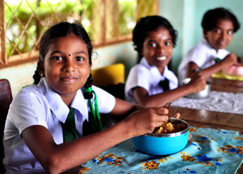 School-aged children receiving their mid-day meal as part of the National School Meal Menu, Sri Lanka
