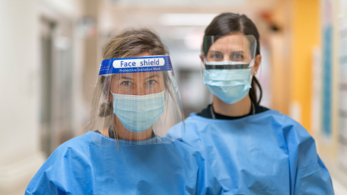 Two doctors wearing face shields