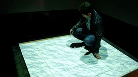person squatting on interactive surface
