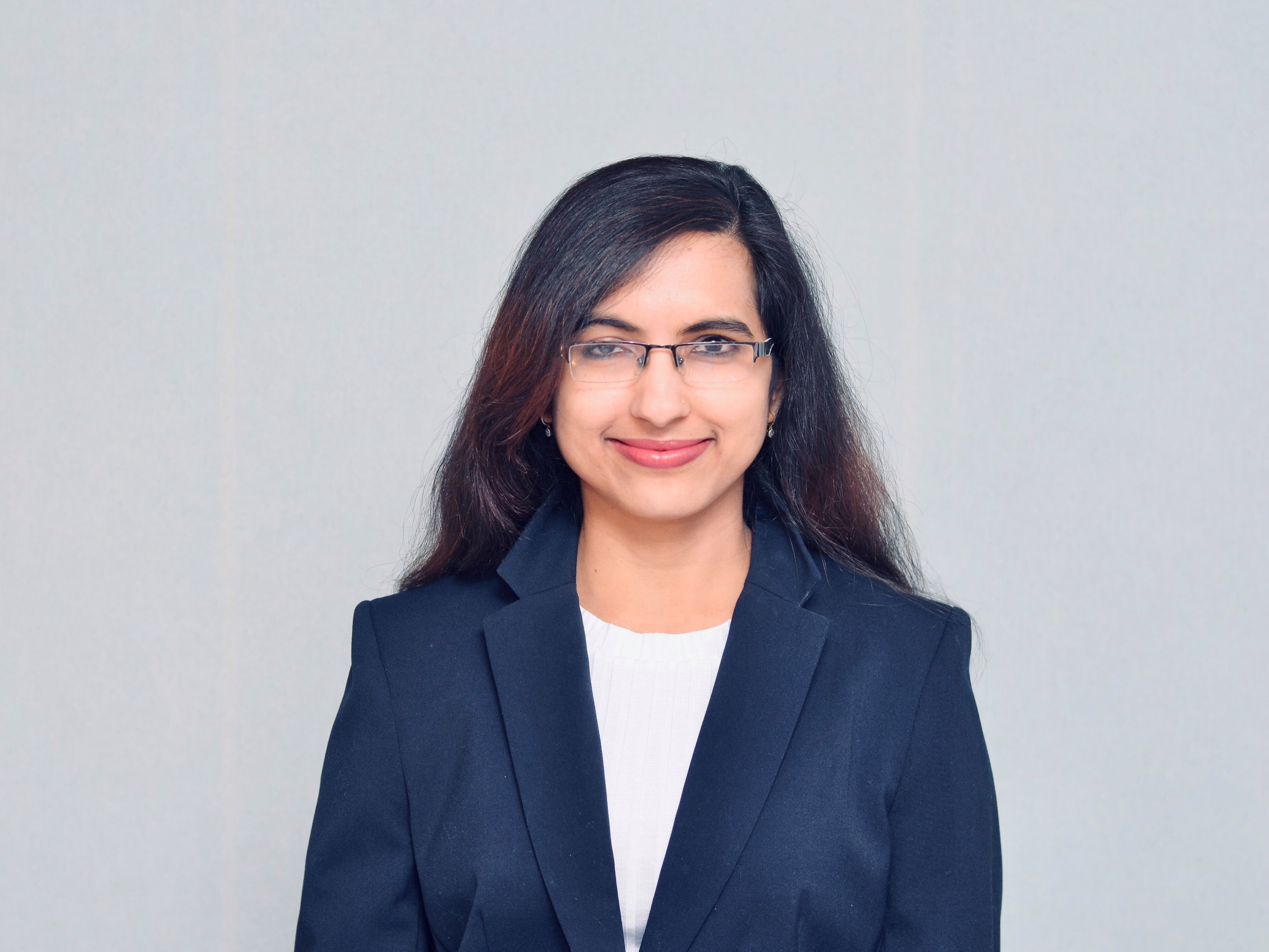 Portrait of Shikha Singh - Young woman with glasses wearing a blazer