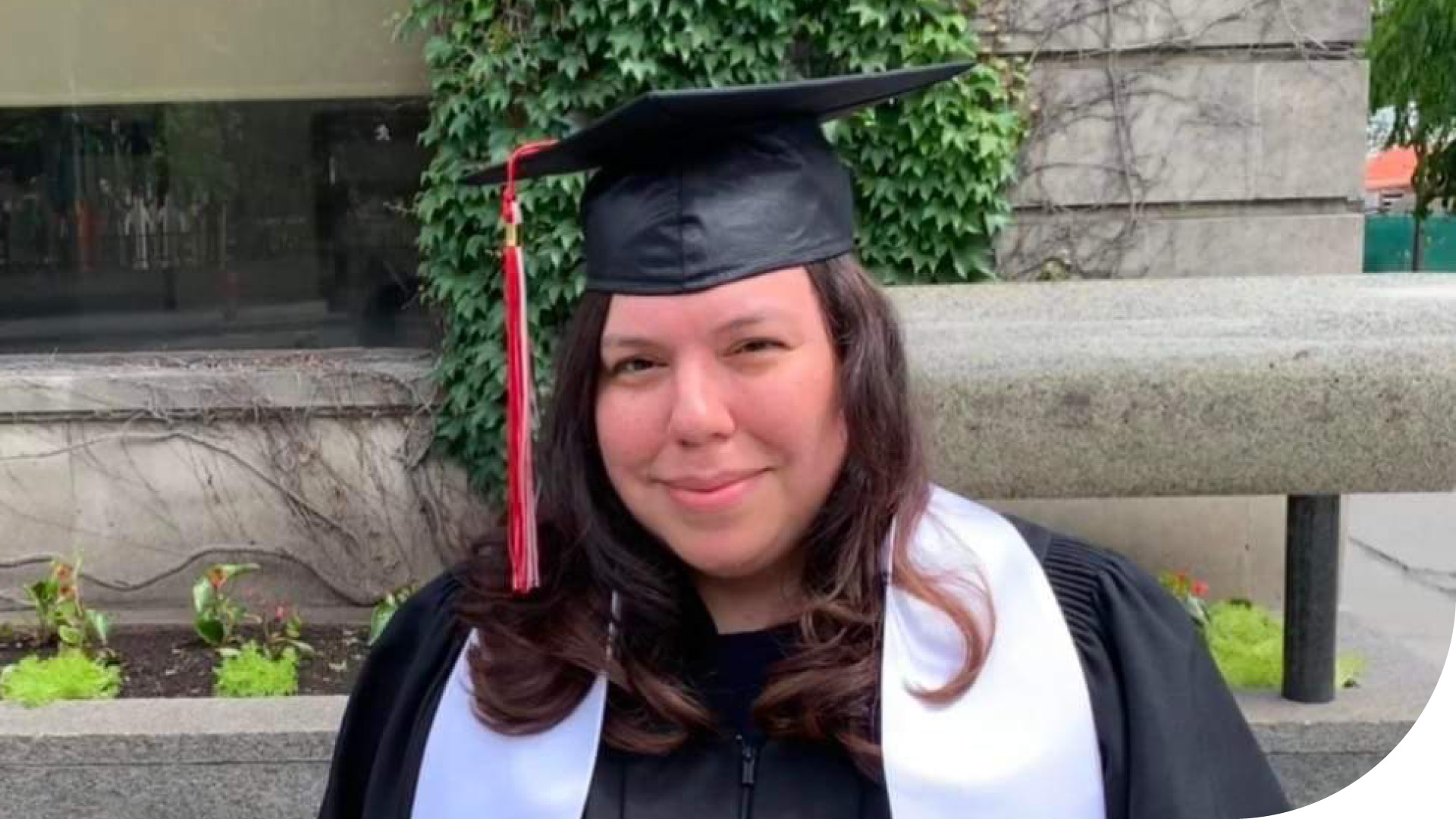 Portrait of learner Rachel Martin wearing a graduation cap and gown