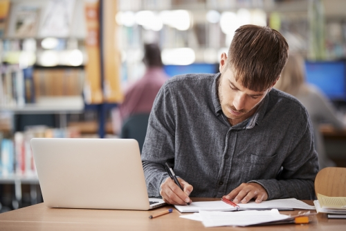 Student writing in notebook