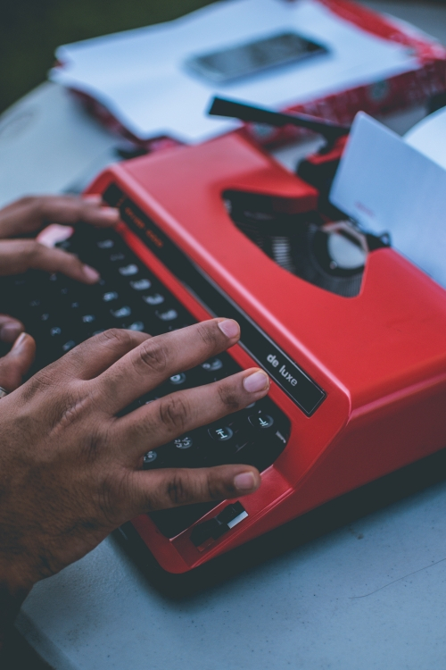 hands typing on a typewriter