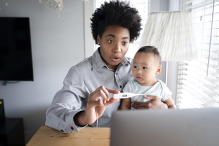 Mom showing baby's fever to doctor through telemedi