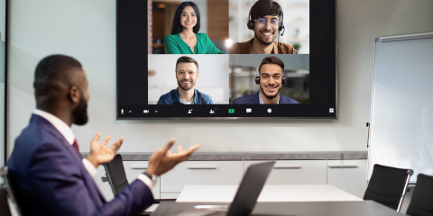 Man in meeting room participating in remote meeting