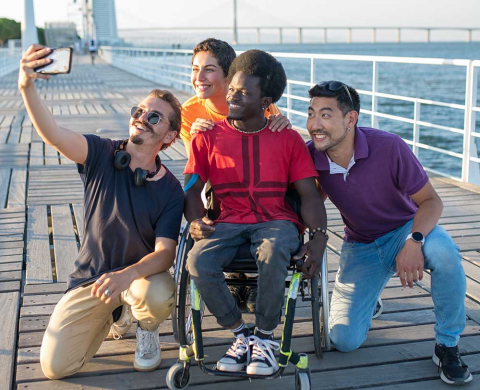 Group of people taking selfie photo with mobile phone