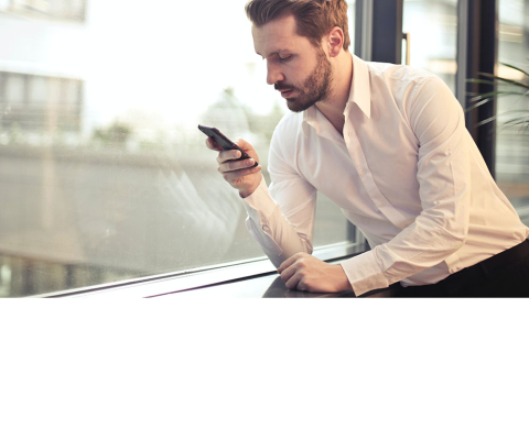 Image of man looking at smartphone