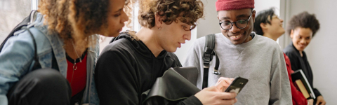 Students looking at a cell phone