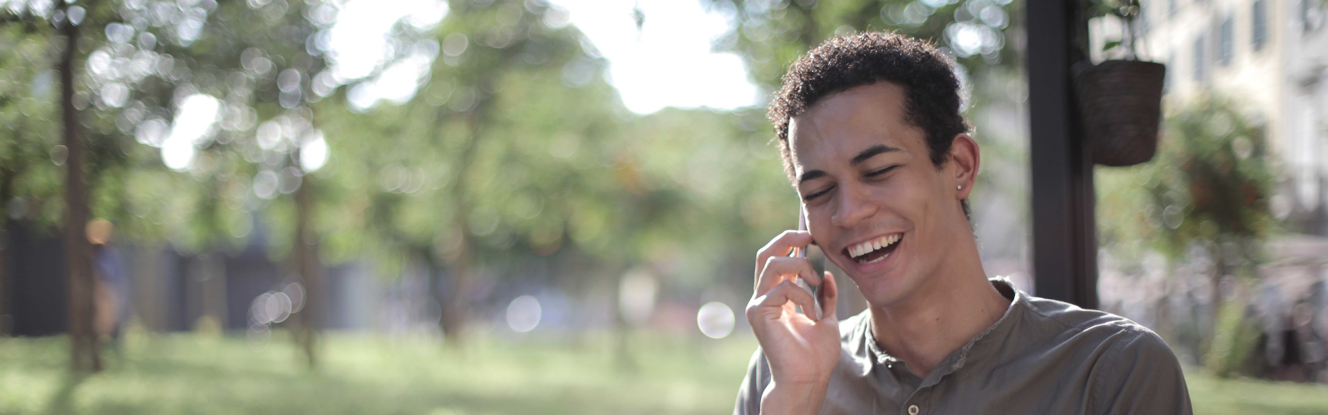 Young man talking on cell phone outside