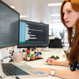 Admin staff member working at desk with computer