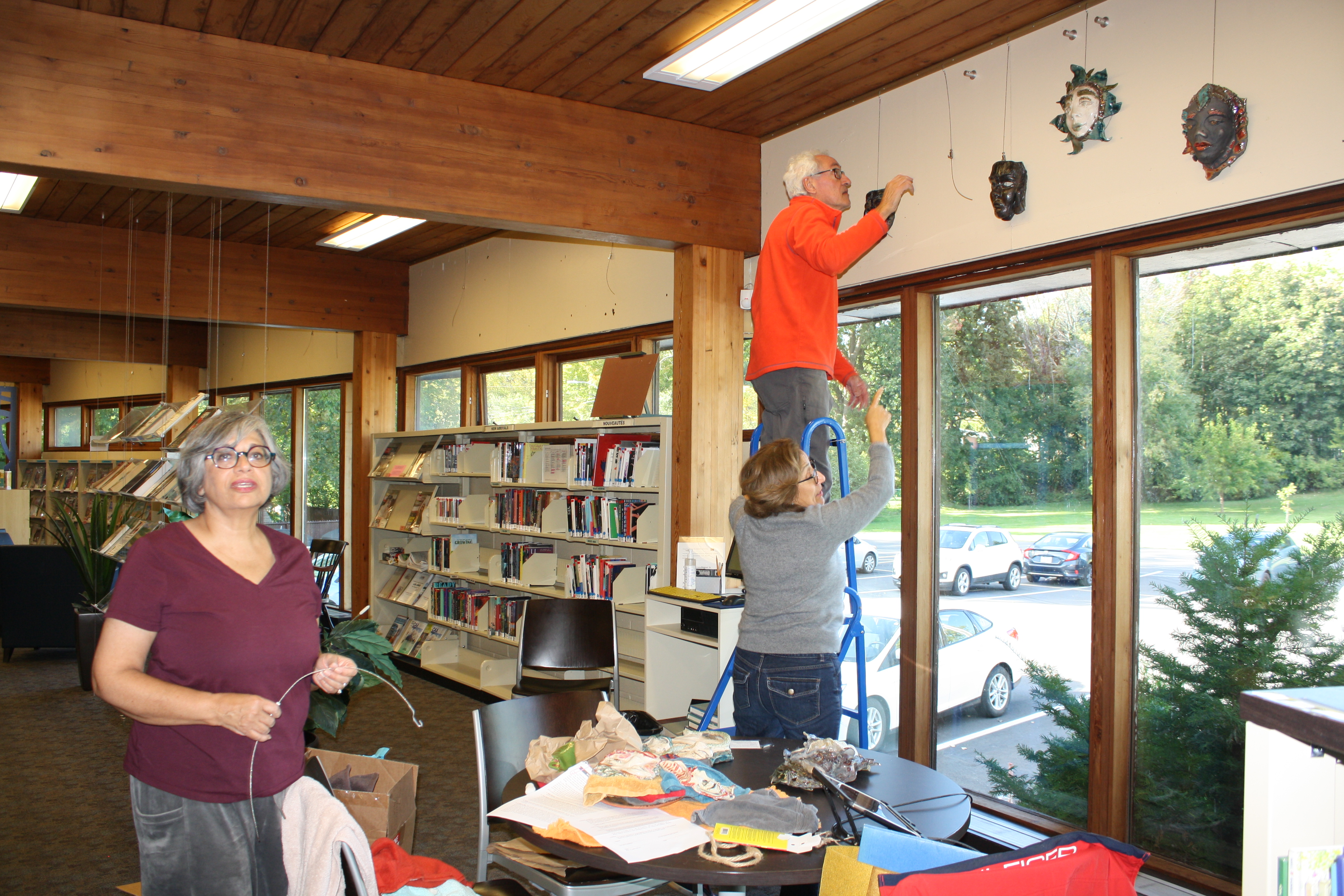 Shaheen Shariff and colleagues in a library putting up the artistic masks she made