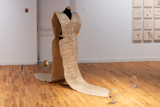 Kama La Mackerel installation (image: mannikin wearing paper with writing on it)