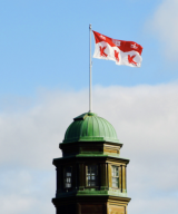 A flag of Mcgill University over a McGill building