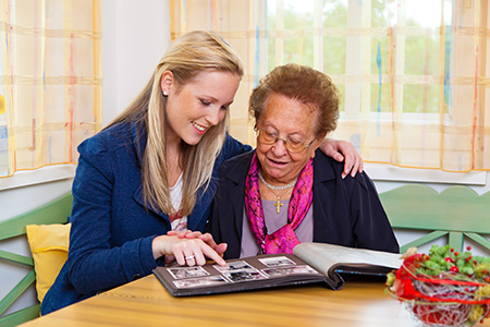 Two women looking at a photo album