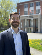 Simon Ducharme smiling in front of the Douglas Instituste